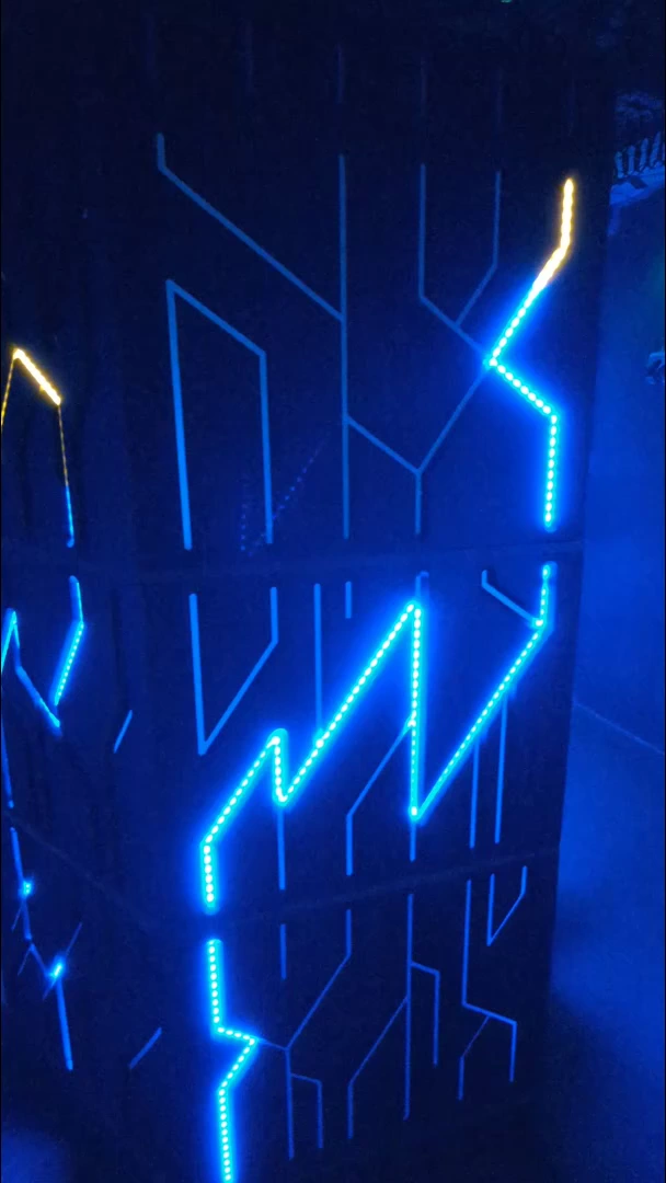 Electric blue branching circuits on the room wall.