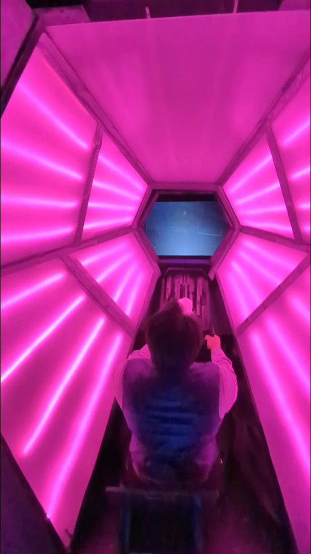 Pink illuminated panels surrounding the hexagonal cockpit display.