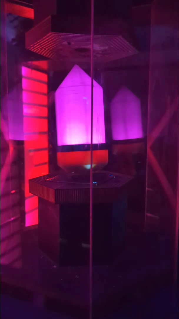 Glowing pink crystal inside the reactor enclosure.