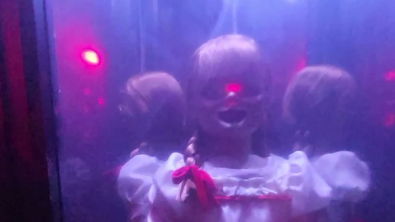 Annabelle doll in her glass case inside The Conjuring experience